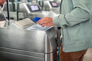 latin Tourist using smartphone to validate electronic ticket at subway station entrance © EDER