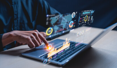 A businessman uses a laptop to access an AI-powered business analytics dashboard, showcasing...