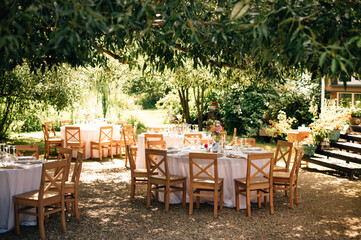 beautiful wedding decor. tables under the tree in the garden