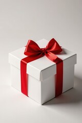 Fototapeta premium Red gift bow tied neatly on a white cardboard box, wrapping, package, holiday