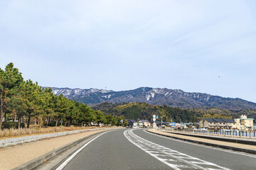 Road Leading Towards Snow-Capped Mountains in Rural Japan