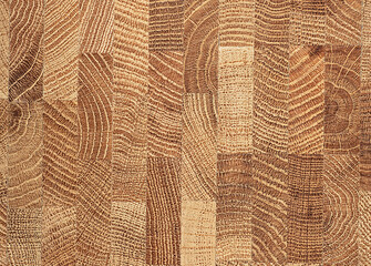 Natural durable end grain hardwood cutting board as background, top view. Cross section of oak tree trunk.