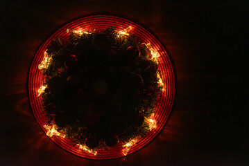 Yellow Christmas lights on a red background, from above