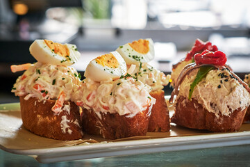 Delicious seafood salad tapa served on toasted bread with garnishes.