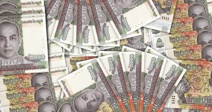 Cambodia money Cambodian riel banknotes in a cash fan mosaic pattern loop. 2000 KHR notes. Abstract concept of bank, finance, economy seamless and looped design background.