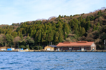 Naklejka premium Rural Japanese Waterfront with Traditional Buildings and Forest, Ine, Kyoto, Japan