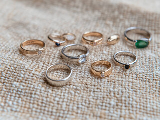 Beautifully arranged display of handmade rings on textured fabric