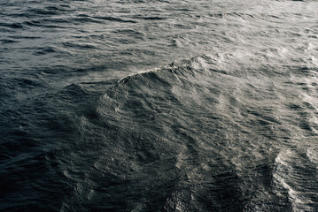 Winter sailing. Cold blue sea at sunset. Waves and clouds