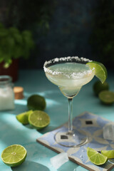 A glass with margarita cocktail with lime