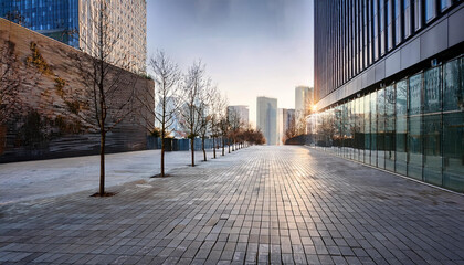 Fototapeta premium a modern urban pedestrian walkway surrounded by contemporary buildings with facades of glass metal and stone the walkway is paved with smooth tiles and features leafless trees in a winter season