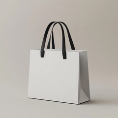 White paper shopping bag with black handles on neutral background.