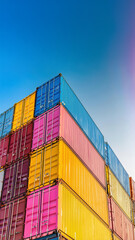 Colorful stacked shipping containers urban port photography clear sky aerial view industrial concept