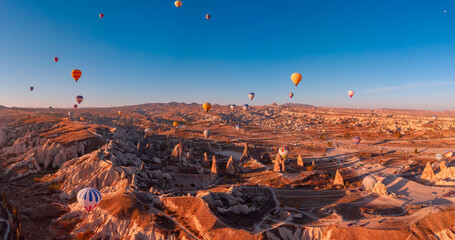 Amazing aerial view of hot air balloons over Cappadocia stunning valleys at sunrise