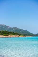 Fototapeta premium Grande Pevero beach with turquoise clear water and boats in Sardinia, Italy