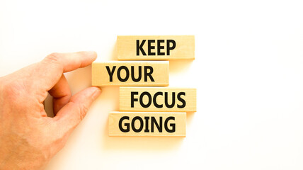 Keep your focus going symbol. Concept words Keep your focus going on beautiful wooden blocks. Beautiful white table white background. Business and keep your focus going concept. Copy space.
