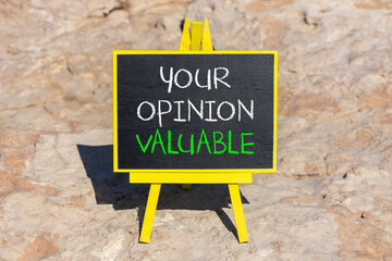 Fototapeta premium Your opinion valuable symbol. Concept words Your opinion valuable on beautiful black yellow blackboard. Beautiful stone background. Business your opinion valuable concept. Copy space.