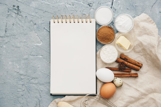 Overhead view of a blank Notepad on a table with assorted baking ingredients and a napkin