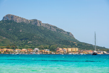 Golfo Aranci beach view from the other side of the bay with turquoise water in Sardinia, Italy
