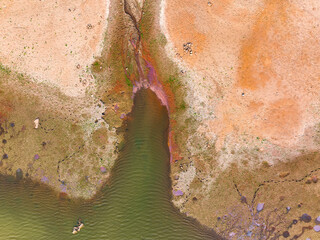 Chemical wastes close up. Dry and cracked ground background. Global warming and climate change....
