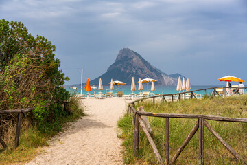 Porto Taverna beach entrance and Tavolara island on a cloudy day in Sardinia, Italy