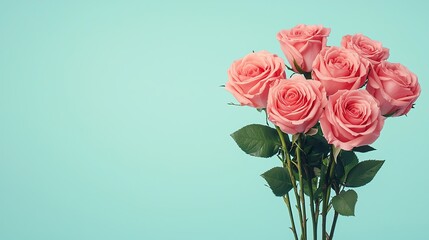 Fototapeta premium A stunning bouquet of pink roses against a soft turquoise background.