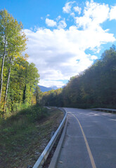 Fototapeta premium paved highway in a mountainous area in early autumn with panoramic views