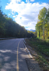 paved highway in a mountainous area in early autumn with panoramic views