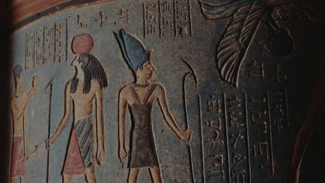 Ancient Egyptian hieroglyphs and figures carved on a clay pot. The artwork depicts pharaohs, deities, and symbols, showcasing the rich history and culture of Egypt. history, culture,