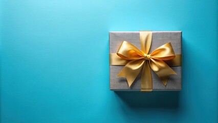 A gray gift box with a gold ribbon bow on a blue background