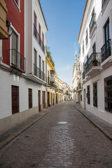 Fototapeta na wymiar Empty street between houses in Cordoba, Spain.