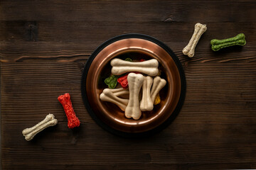 Bowl full of chew bones for dog. Food and treats for pets