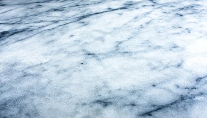 A smooth marble surface with elegant veining in shades of white and gray, showcasing its natural beauty and texture.
