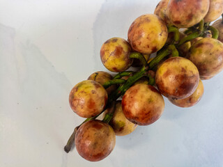 Kepundung or rambai fruits (Baccaurea racemosa or ramiflora or motleyana), isolated on white background.