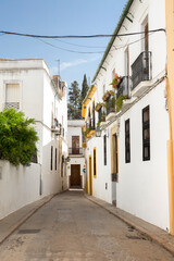 Empty street between houses in Cordoba, Spain.