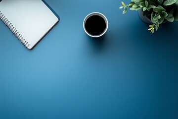 Organized Workspace with Laptop, Coffee, and Stationery on Blue Background