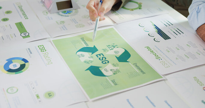 Closeup group Asia businesspeople talk ESG strategies risk management workshop, SDGs report, global warming, green finance investment eco friendly and net zero waste in boardroom training building.