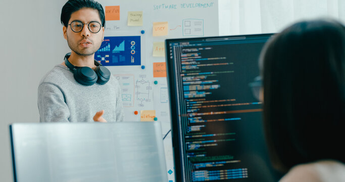Group adult Asia male female software developers mentor leader manager talk strategy plan to executive write prompt AI bot IT app program nomad, video game, data center. Whiteboard slideshow code.