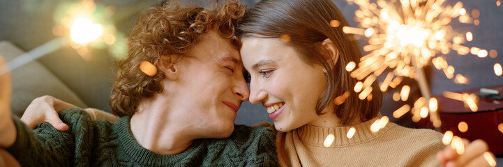 Website banner with adorable and lovely couple cuddling while holding lit Bengal lights