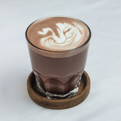 Hot chocolate with swan latte art on white background