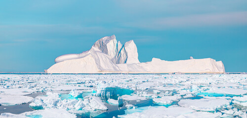 Melting icebergs by the coast of Greenland, on a beautiful summer day - Melting of a iceberg and pouring water into the sea - Greenland