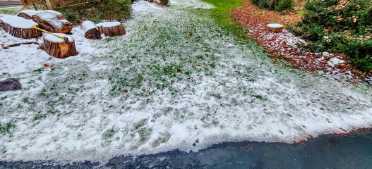 Outdoor photo of some snow on the grass and other areas