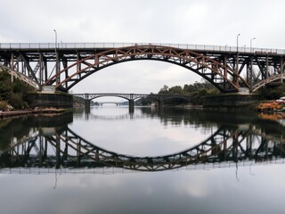 Fototapeta premium Bridge in the distance with reflected image, water, peaceful