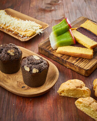 An assortment of fresh pastries and snacks is displayed on rustic wooden platters, showcasing tempting textures and flavors