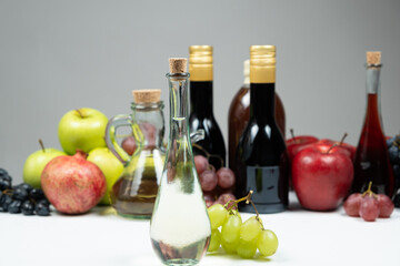 White wine vinegar in a vinegar bowl against the background of other types of bottled vinegars