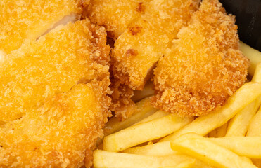 Breaded chicken with french fries take away closeup, roasted breaded meat fillet