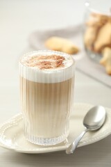 Tasty latte macchiato in glass on white table, closeup. Coffee drink