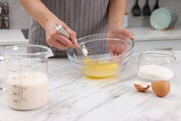 Woman making dough at white marble table indoors, closeup