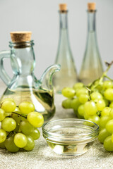 White wine vinegar in a vinegar bowl among grapes