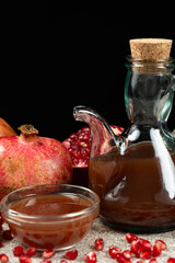 Natural Traditional Pomegranate Vinegar in Vinegar Cruet on Black Background