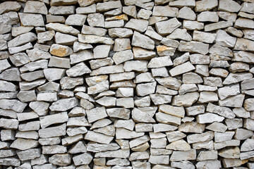 Background of stone wall. Stone wall texture with different sized stones as background.